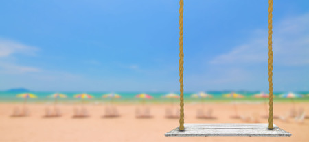 Old wooden plank with umbrella and sit for relax with blue sky background on the summer beachの写真素材