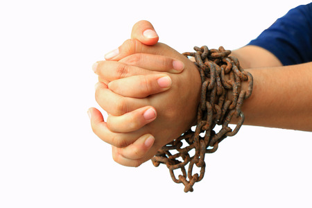 Man's hands tied with chains isolated on white backgroundの写真素材
