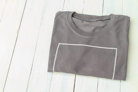 T-shirts put on white wooden table top backgroundの写真素材