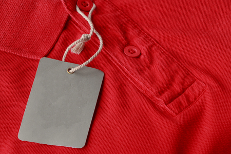 Close up red polo shirt with blank tags for sell at the shopの写真素材