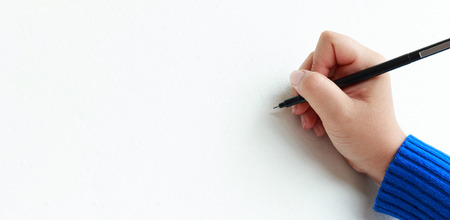 Woman hand use pen writing something on white blank space background use for insert textsの写真素材