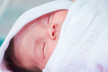 Newborn baby boy in bedの写真素材