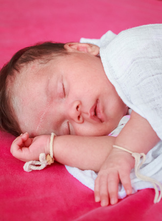 Newborn baby boy in bedの写真素材