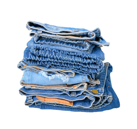 Stack of blue jeans on white background with copy spaceの写真素材
