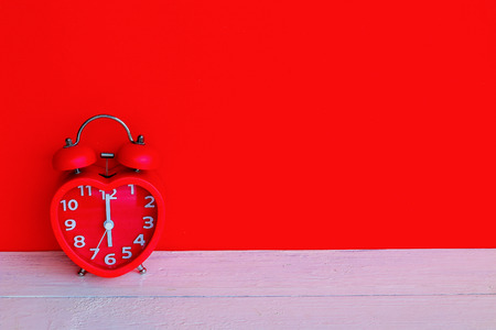 Close up red alarm clock mark at 6 o'clock in the morningの写真素材