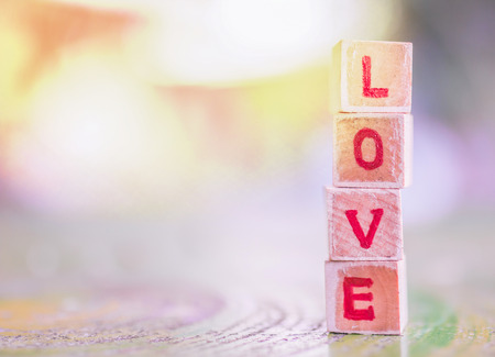 Love message written in wooden blocks. Valentines day card concept. Heart for Valentines Day Background.の写真素材