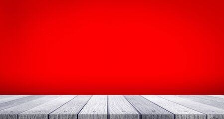 wooden table top with color red background use for products show or displayの写真素材