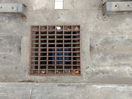 Metal gratings street to prevent flood and cover sewage drain wayの写真素材