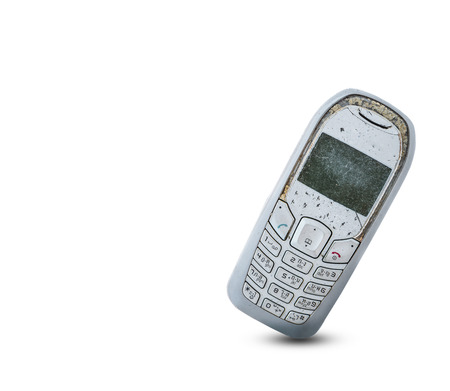 Close up rustic vintage mobile phone isolated on white backgroundの写真素材