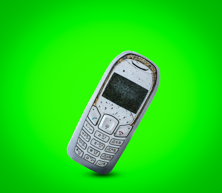 Close up rustic vintage mobile phone isolated on white backgroundの写真素材