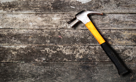 Close up top view of yellow hammer on wooden backgroundの写真素材