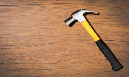Close up top view of yellow hammer on wooden backgroundの写真素材
