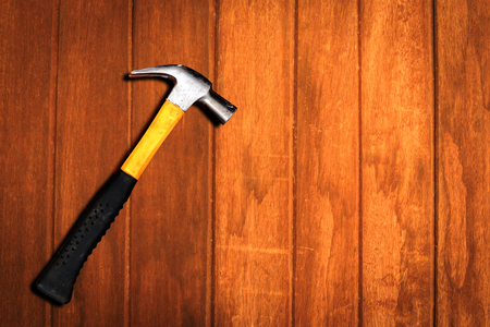 Close up top view of yellow hammer on wooden backgroundの写真素材