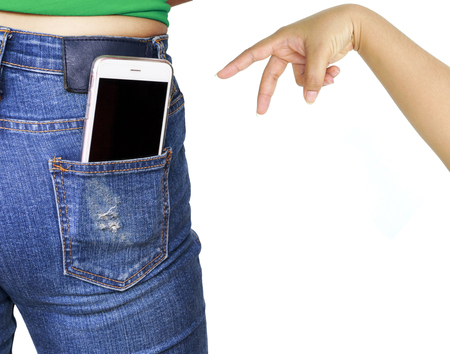 Thief hand trying to stole mobile phone in woman pocket jeansの写真素材