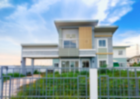 Blurred image of house with blue sky backgroundの写真素材