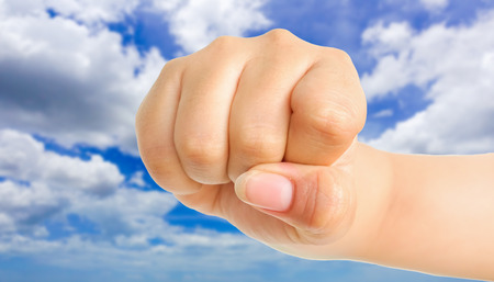 human hand showing gesture with blue sky backgroundの写真素材