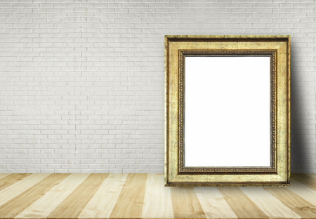 Close up blank picture frame put on table with brick wall background use for text or product displayの写真素材