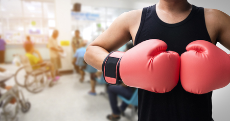 human with glove punch with blurred hospital background, Sick fighting concept.の写真素材
