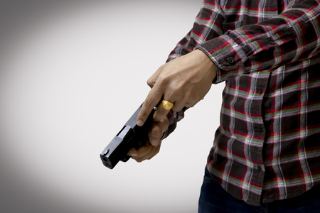 Close up male hand holding gun for shootingの写真素材