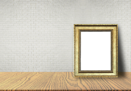 Close up blank picture frame put on table with brick wall background use for text or product displayの写真素材