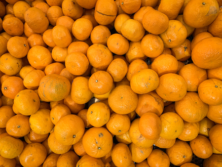 Close up many orange fruit background for sell at the marketの写真素材