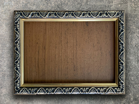 Close up old rustic picture frame on cement wall texture backgroundの写真素材