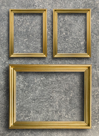 Close up luxury vintage golden picture frame on rust cement wall backgroundの写真素材