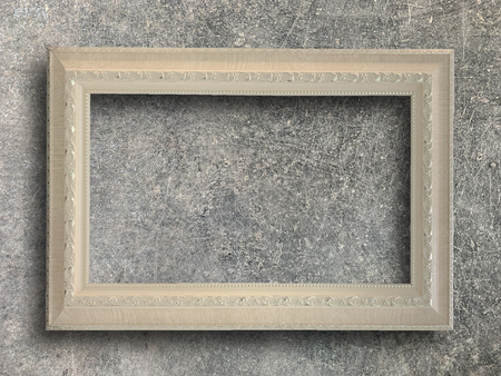 Close up old rustic picture frame on cement wall texture backgroundの写真素材