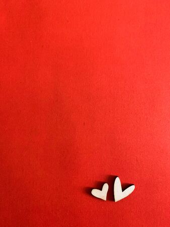 Close up top view of heart sign made with wooden put on red background, Valentine day concept.の写真素材
