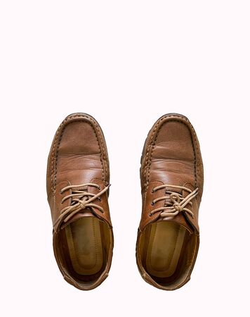 Old Brown leather shoes isolated on white backgroundの写真素材