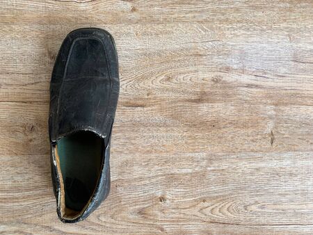 Close up retro old vintage leather shoe put on wooden table topの写真素材