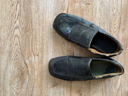 Close up retro old vintage leather shoe put on wooden table topの写真素材