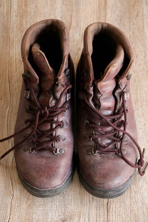 Close up retro old vintage leather shoe put on wooden table topの写真素材