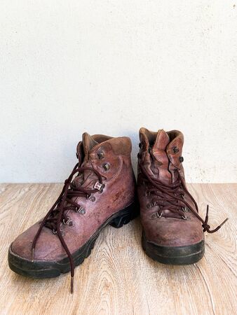 Close up old leather shoes on wooden table backgroundの写真素材