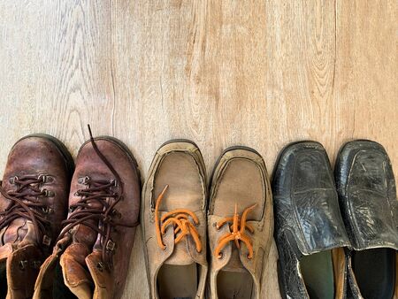 Close up old leather shoes on wooden table backgroundの写真素材