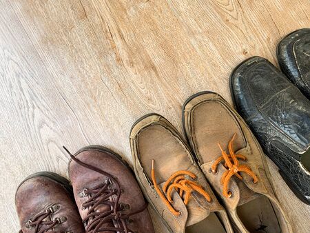 Close up old leather shoes on wooden table background