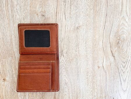 Close up brown leather luxury wallet put on wooden table backgroundの写真素材