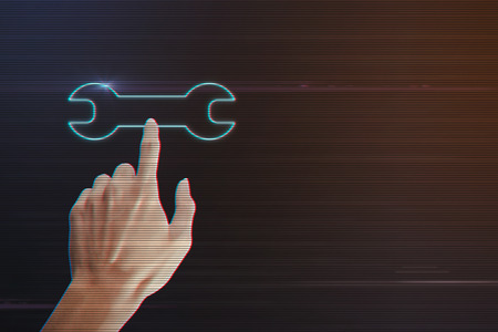 Human Hand Pressing Wrench Icon on Light Motion Background and Lens Flare - Digital 3d Effect Style Colorの写真素材