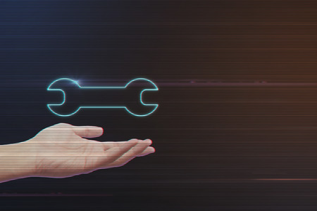 Human Hand Holding Wrench Icon on Light Motion Background and Lens Flare - Digital 3d Effect Style Colorの写真素材
