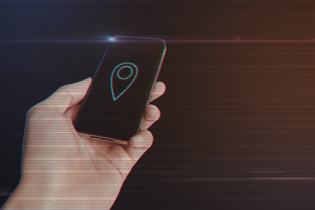 Close up of man hand holding smartphone with Location Pin Icon on Light Motion Background and Lens Flare - Digital 3d Effect Style Colorの写真素材