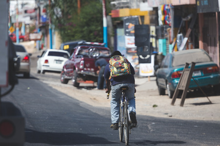 Bicycle rider on side of road in chimaltenango, Guatemala, Central America.の写真素材