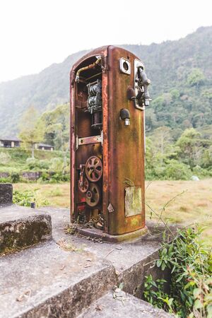 Heavily rusted, antique gas pump in the remote jungle near Lake Atitlan, Guatemala, Central America.の写真素材
