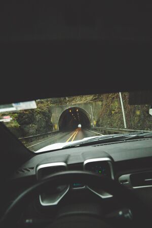 Driver's point of view from inside car, approaching a highway tunnel in western Oregon, USA.の写真素材