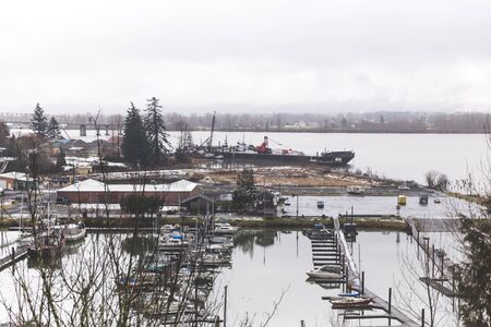 Overlooking boat docks under cloudy winter sky on the Oregon coast.の写真素材