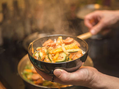Rice, vegetables, and meat in freshly cooked meal.の写真素材