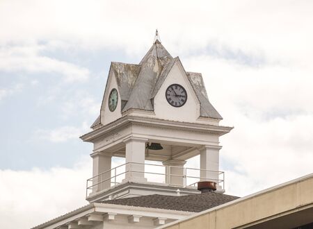 Clock Tower on top of a building on a bright summer day.の写真素材