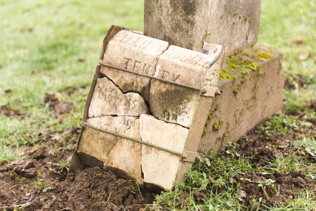 Grave yard tomb stone in misty, green cemetery.の写真素材