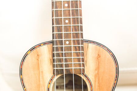 New, upscale ukulele with four strings and unique, textured wood grain finish.の写真素材