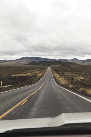 Two-lane highway trailing off into the distance. Driver's point of view on rural highway in Oregon, USA.の写真素材