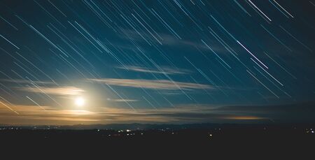 Long exposure shot of stars moving across the sky at dusk.の写真素材